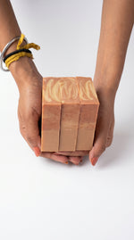 Juna Tangerine Bloom handmade citrus soap bars held in hands photo